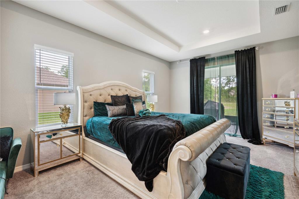 5239 Southwest 114th Street Road Ocala, FL 34476 - Photo 17 of 42 a bedroom with a bed and a window