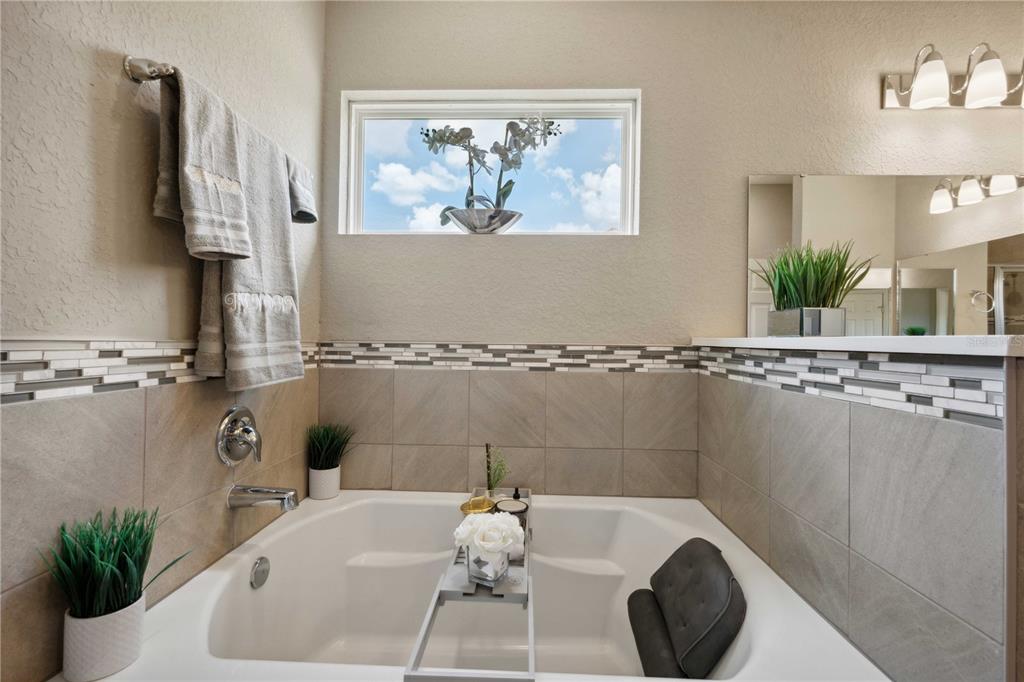 5239 Southwest 114th Street Road Ocala, FL 34476 - Photo 20 of 42 a bath tub sitting next to a white sink