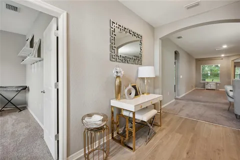 a view of a livingroom with furniture and a mirror