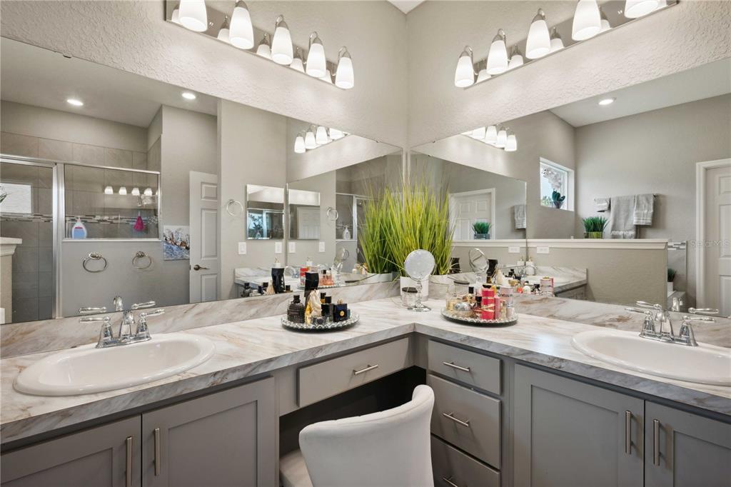 5239 Southwest 114th Street Road Ocala, FL 34476 - Photo 23 of 42 a bathroom with a sink vanity and a mirror