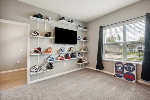 a bedroom with furniture and a flat screen tv