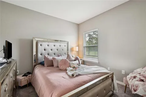 a bathroom with a sink a toilet a mirror and shower curtain