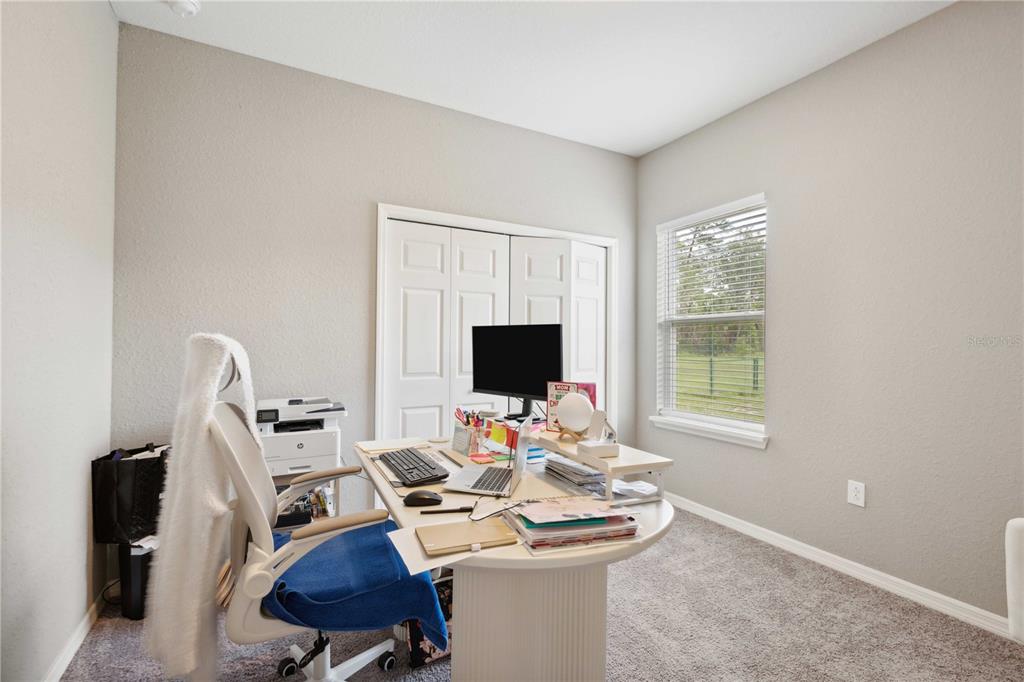 5239 Southwest 114th Street Road Ocala, FL 34476 - Photo 28 of 42 a work room with furniture and a flat screen tv