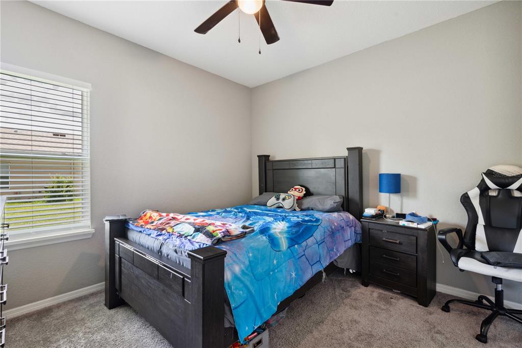 5239 Southwest 114th Street Road Ocala, FL 34476 - Photo 29 of 42 a bedroom with a bed and a tv