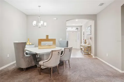 a view of a dining room with furniture and chandelier