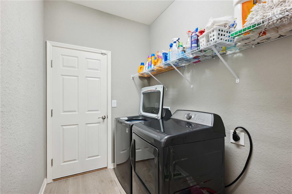 5239 Southwest 114th Street Road Ocala, FL 34476 - Photo 31 of 42 a utility room with sink dryer and washer