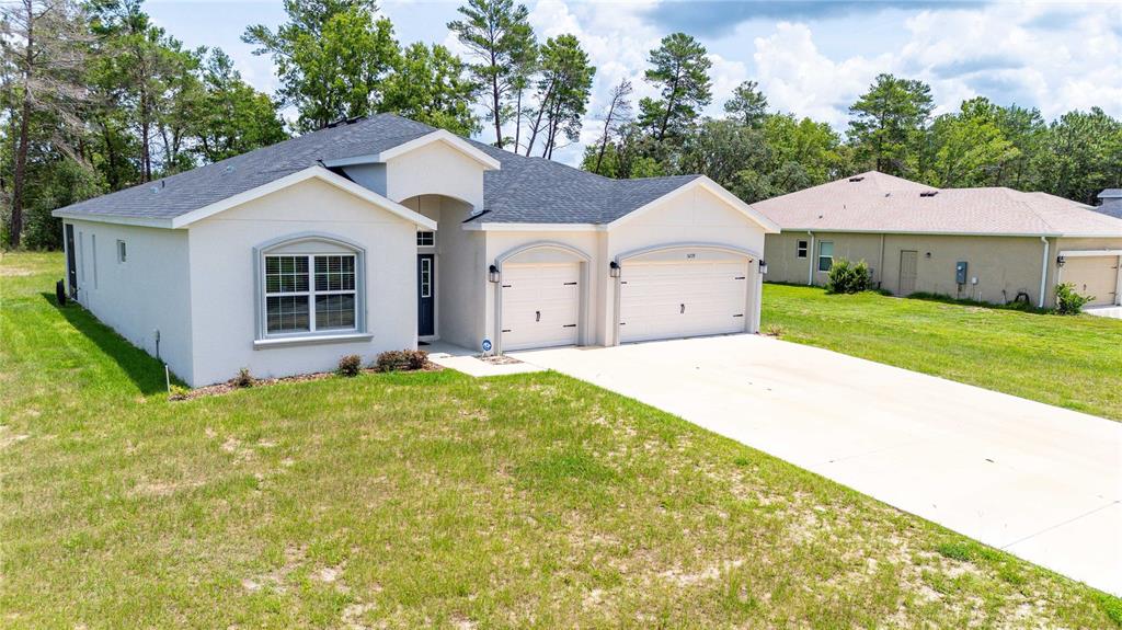 5239 Southwest 114th Street Road Ocala, FL 34476 - Photo 36 of 42 a view of a big house with a yard and large tree