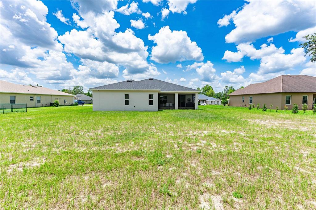 5239 Southwest 114th Street Road Ocala, FL 34476 - Photo 39 of 42 a view of a house with a big yard and large trees