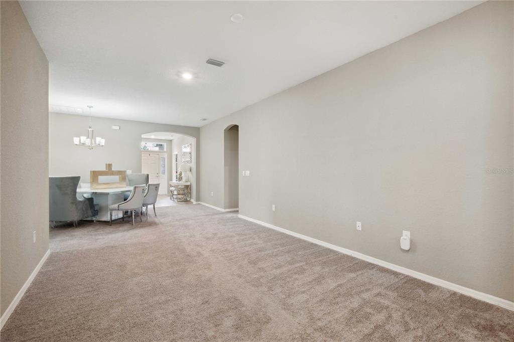 5239 Southwest 114th Street Road Ocala, FL 34476 - Photo 4 of 42 a view of a livingroom with a dinning table and a couch