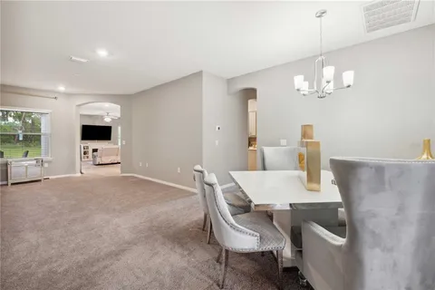 a view of a dining room with furniture and chandelier