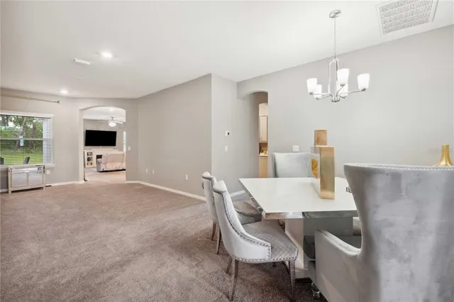 a view of a dining room with furniture and chandelier