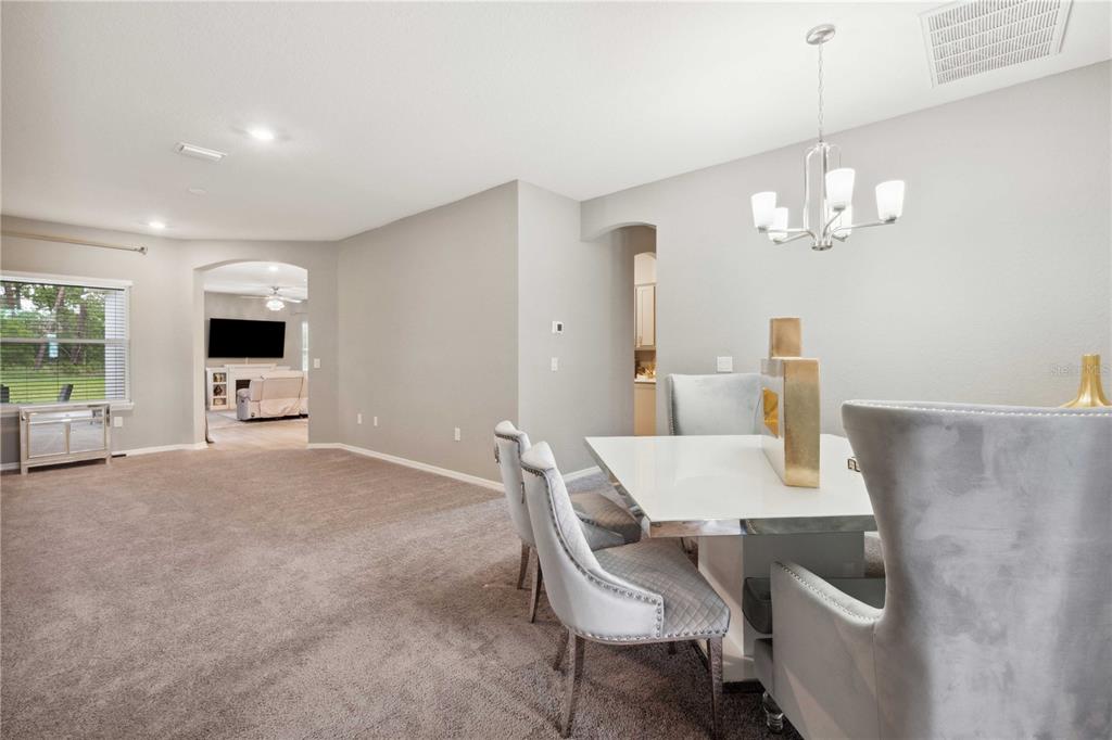 5239 Southwest 114th Street Road Ocala, FL 34476 - Photo 5 of 42 a view of a dining room with furniture and chandelier