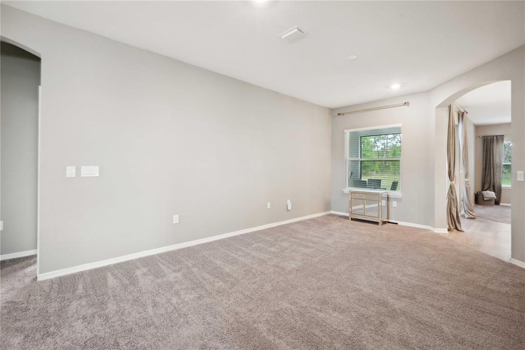 5239 Southwest 114th Street Road Ocala, FL 34476 - Photo 6 of 42 an empty room with windows