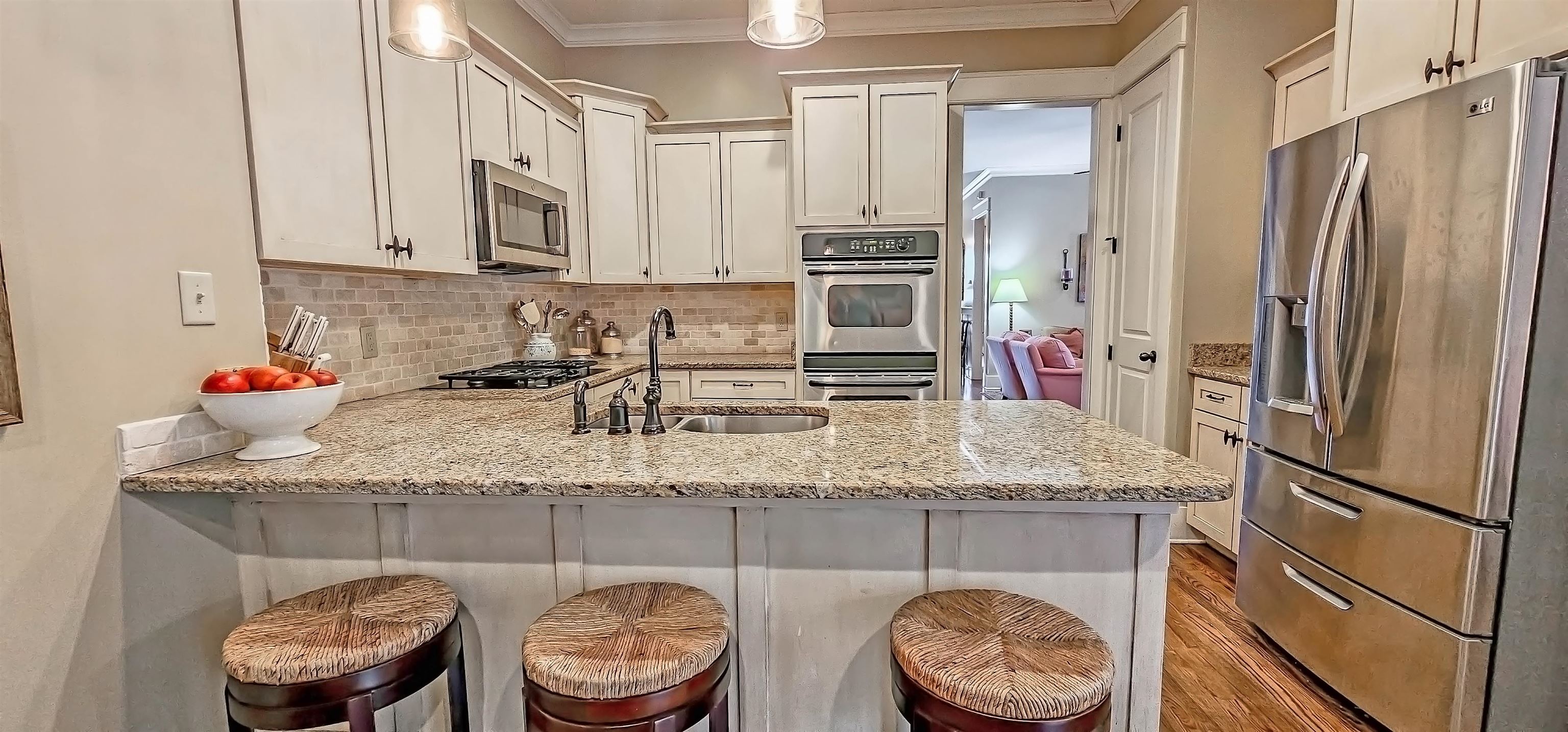 1784 Penshurst Drive Collierville, TN 38017 - Photo 13 of 40 a kitchen with stainless steel appliances granite countertop a sink refrigerator and cabinets