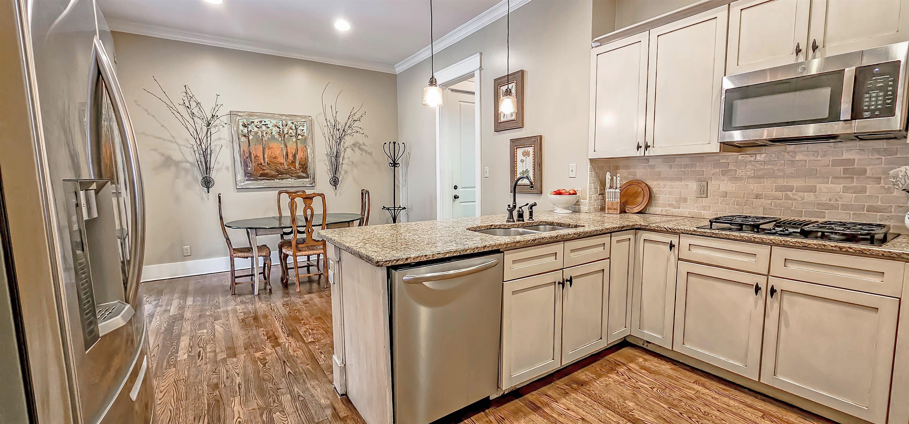 1784 Penshurst Drive Collierville, TN 38017 - Photo 15 of 40 a kitchen with a sink stove and cabinets