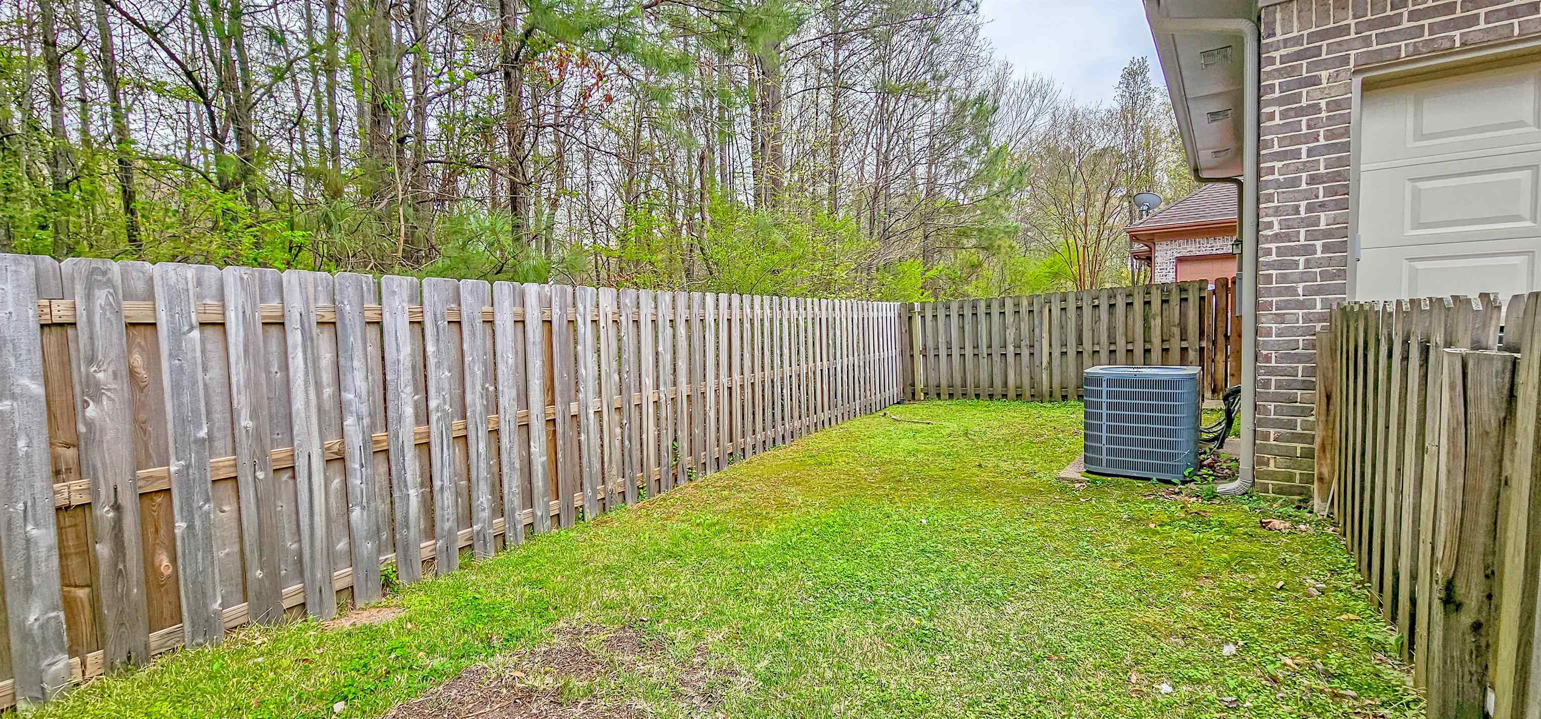 1784 Penshurst Drive Collierville, TN 38017 - Photo 32 of 40 a view of a garden with wooden fence