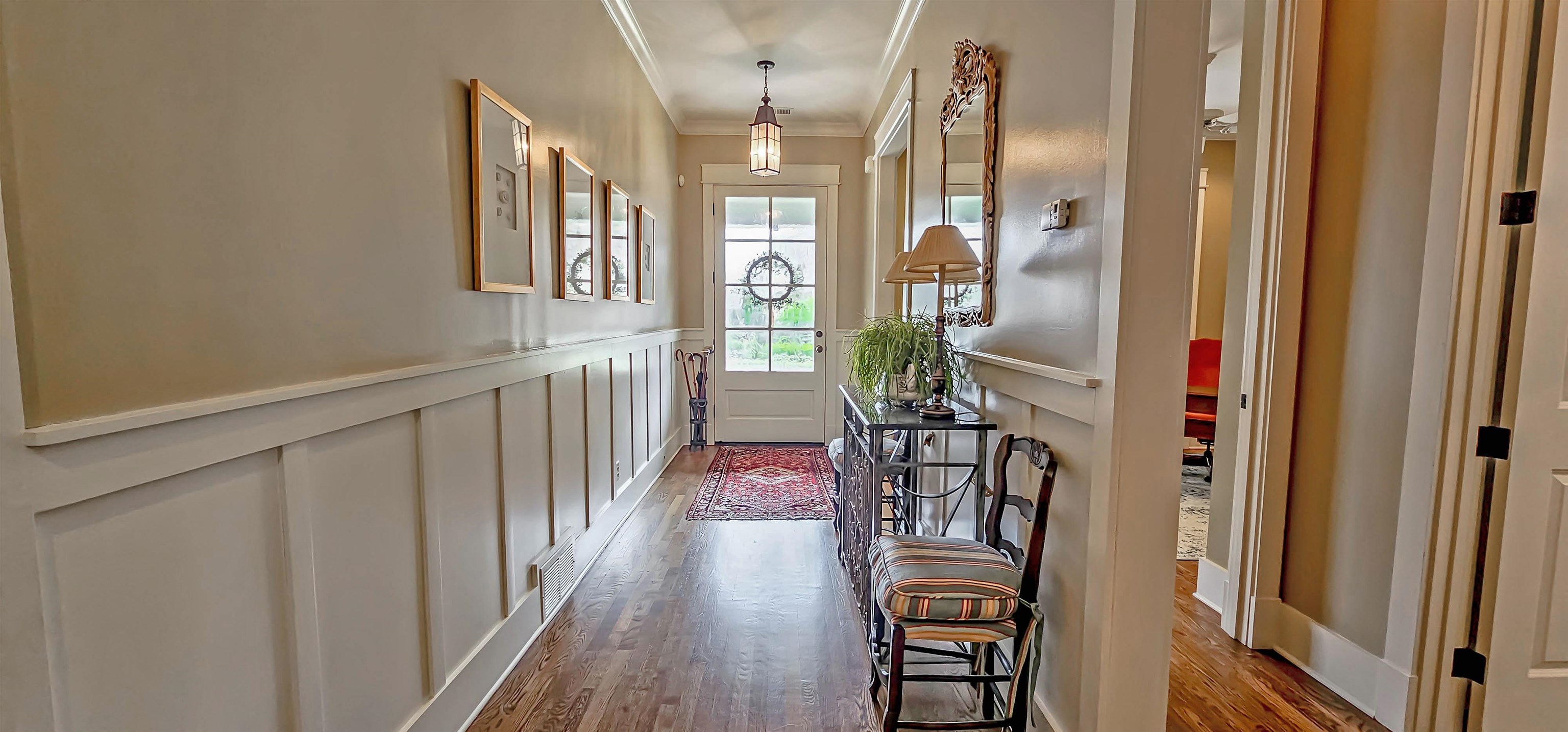1784 Penshurst Drive Collierville, TN 38017 - Photo 4 of 40 a view of a hallway with wooden floor and staircase