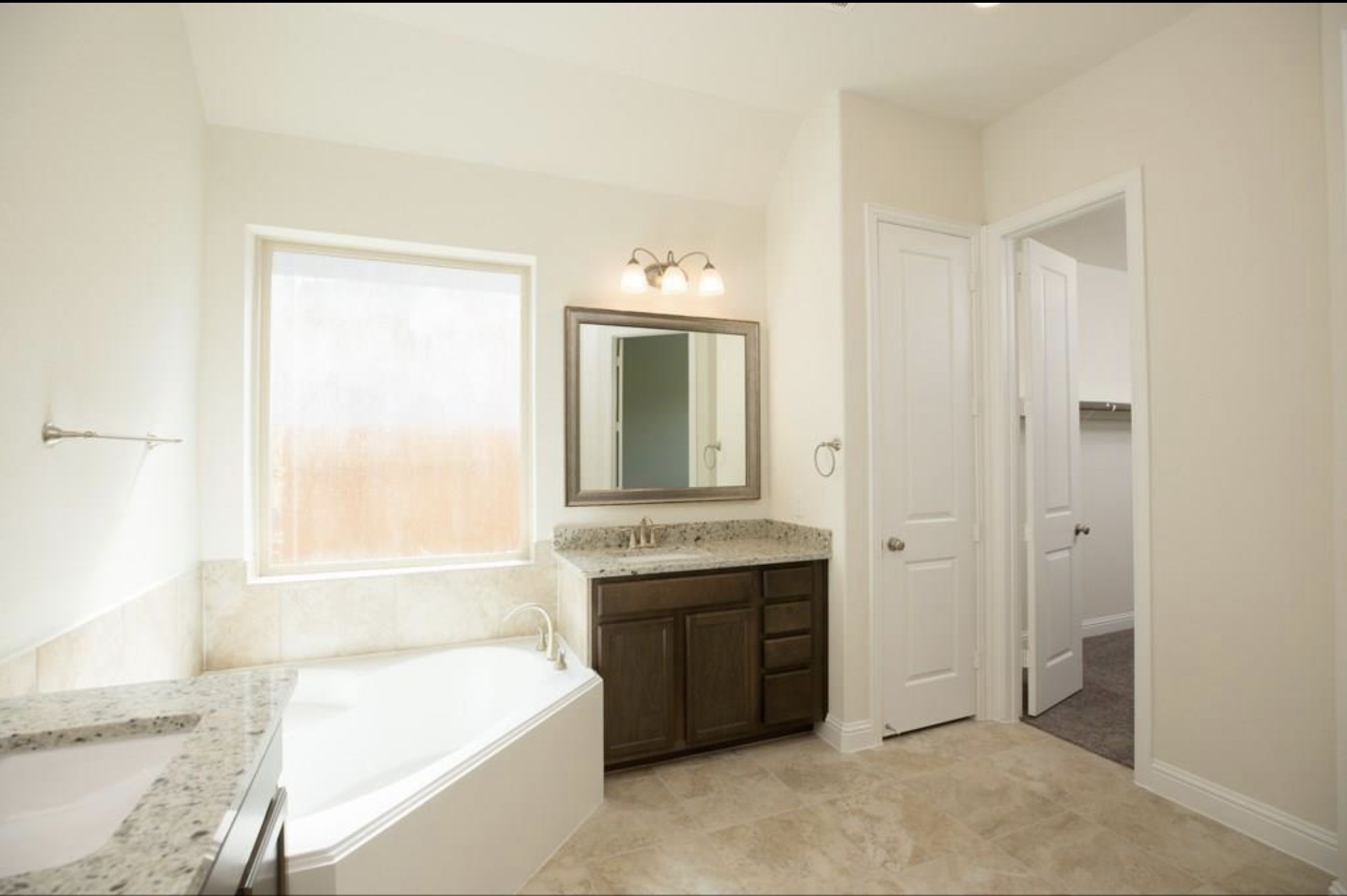 7438 Bethpage Lane Spring, TX 77389 - Photo 12 of 16 a spacious bathroom with a tub sink and mirror