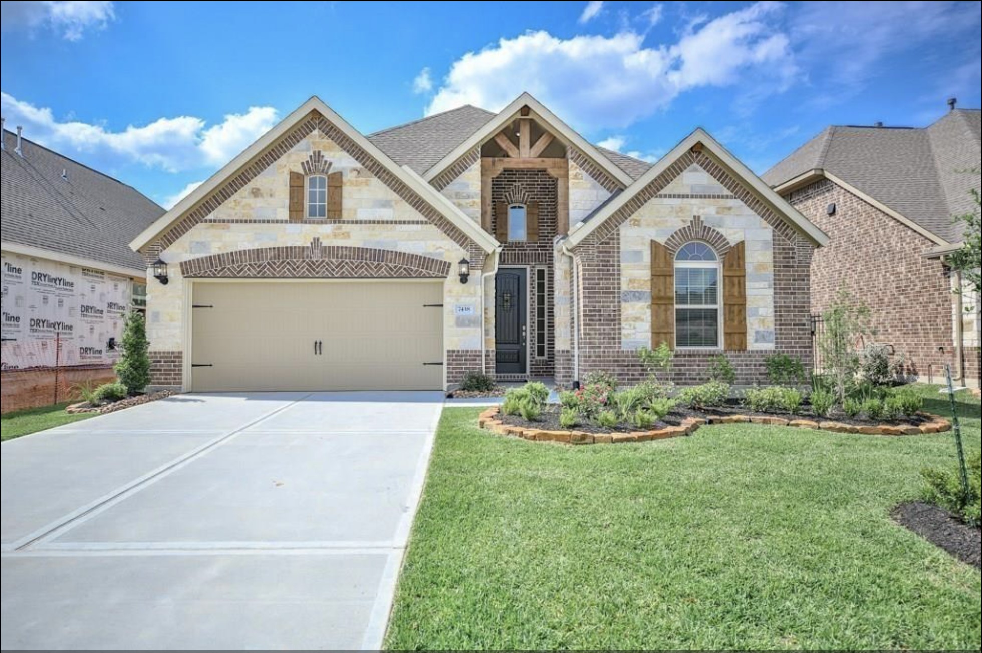 7438 Bethpage Lane Spring, TX 77389 - Photo 2 of 16 a front view of a house with a garden and yard