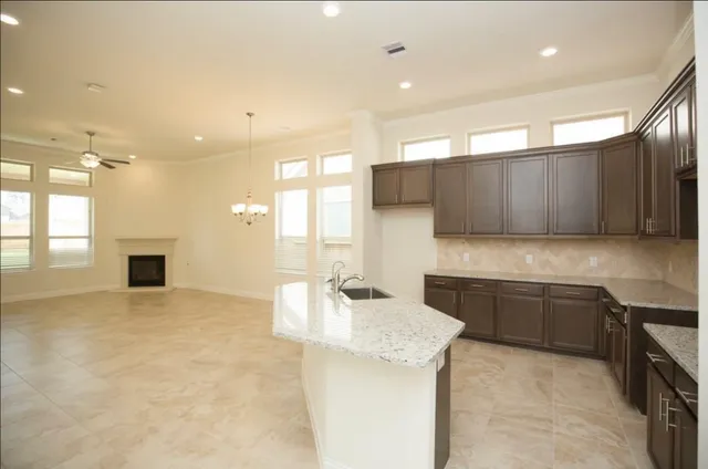 a kitchen with stainless steel appliances granite countertop a sink and cabinets