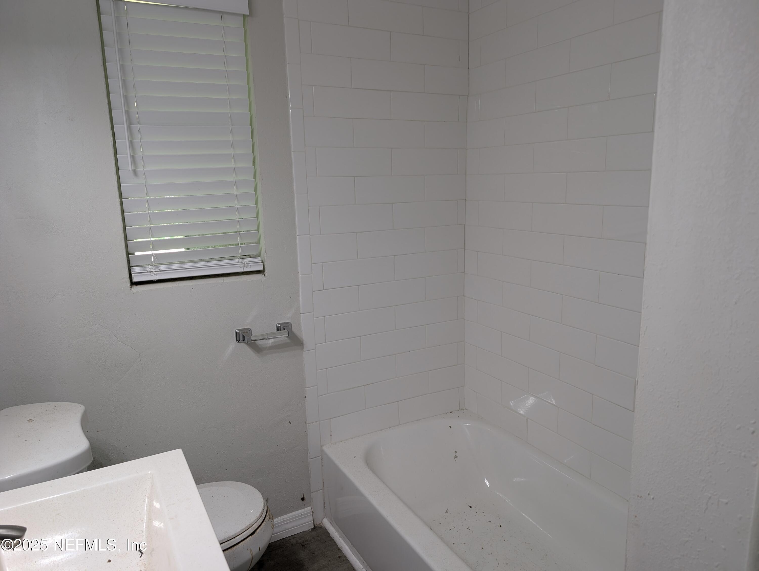 1339 Ellis Road South Jacksonville, FL 32205 - Photo 15 of 26 a bathroom with a bathtub and toilet