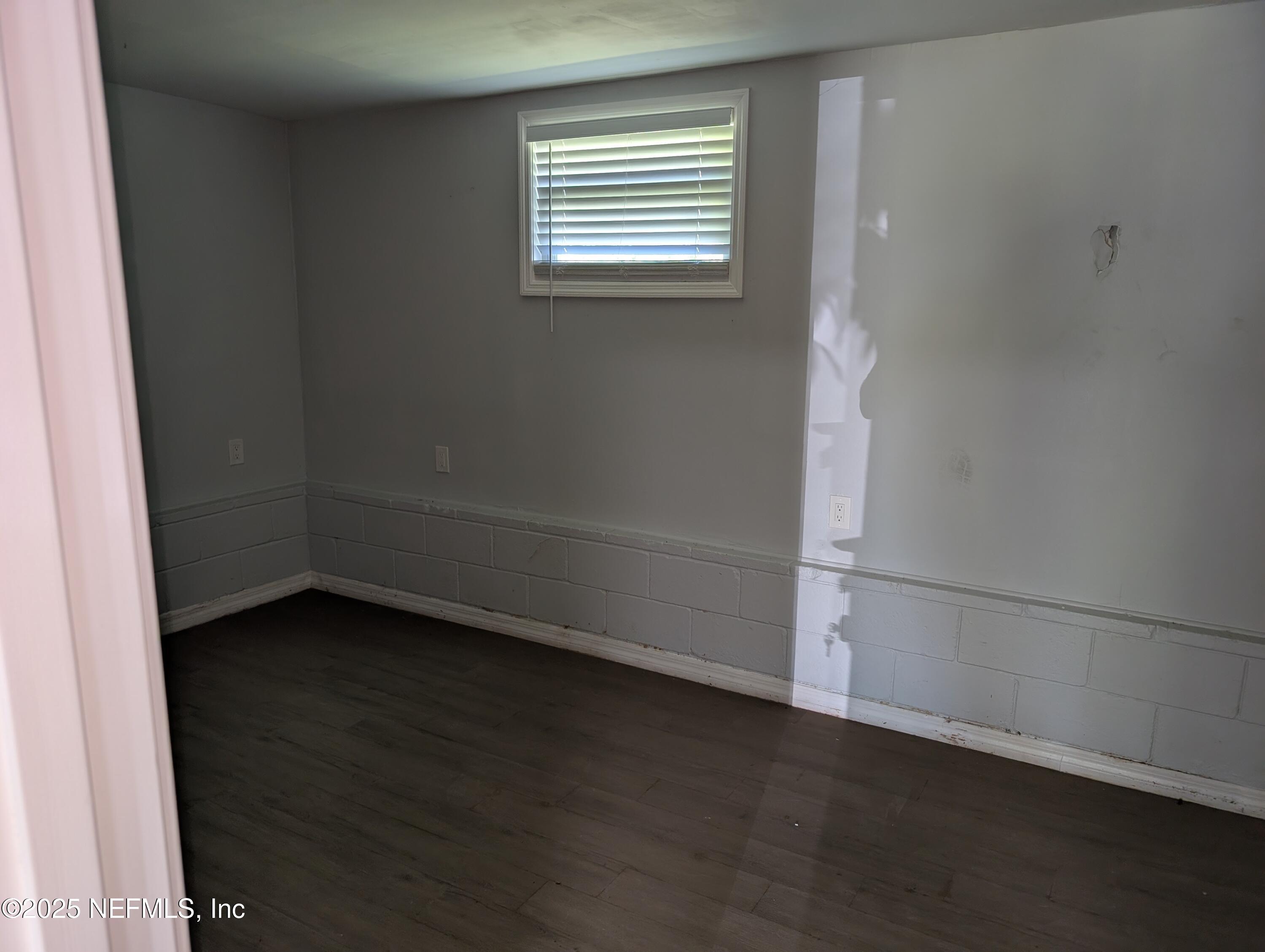 1339 Ellis Road South Jacksonville, FL 32205 - Photo 10 of 26 an empty room with wooden floor and windows