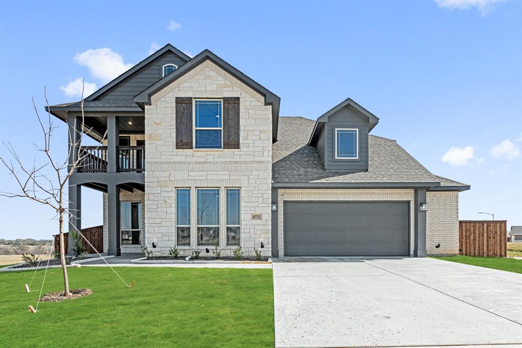 a front view of a house with a garden and yard