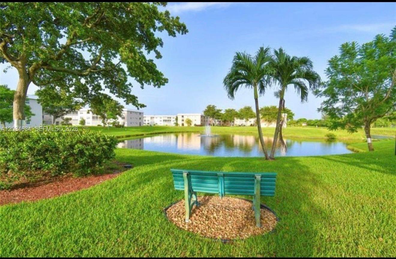 9880 Marina Boulevard, Unit 1516 Boca Raton, FL 33428 - Photo 26 of 32 a swimming pool with wooden fence