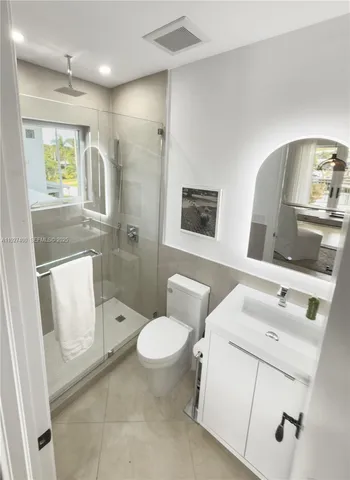 a white toilet sitting next to a bathroom sink