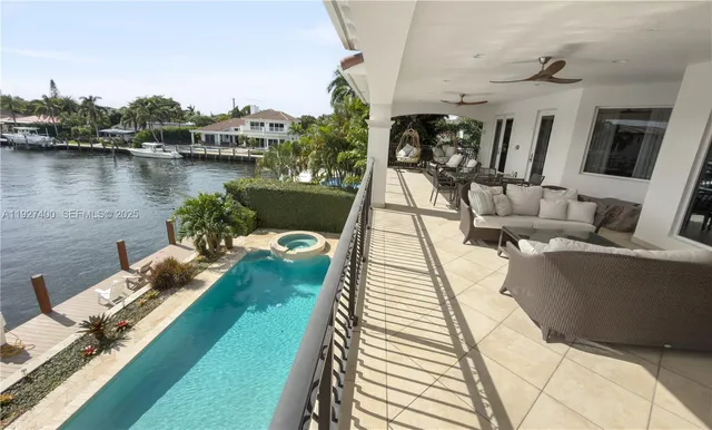 a view of a patio with couches chairs and a wooden floor