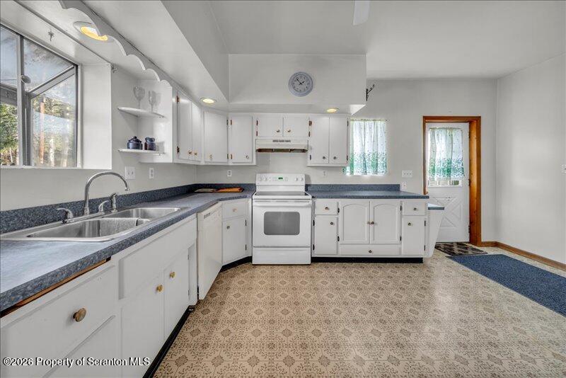 1228 Lake Road Factoryville, PA 18419 - Photo 18 of 43 a large kitchen with stainless steel appliances granite countertop a sink and cabinets