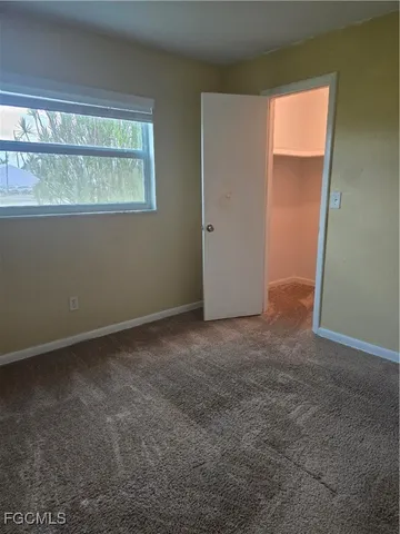 a bathroom with a sink a toilet a mirror and shower