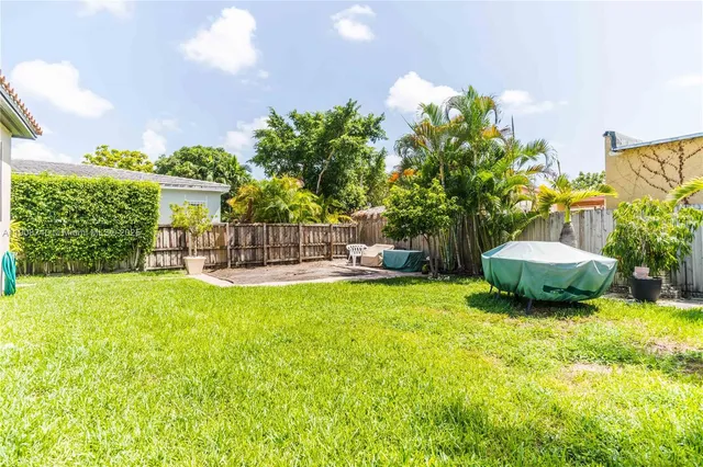 a view of a chair and table in the garden