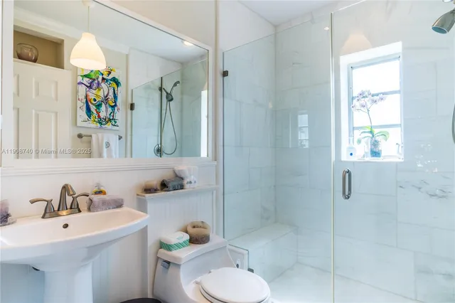 a bathroom with a sink toilet and shower