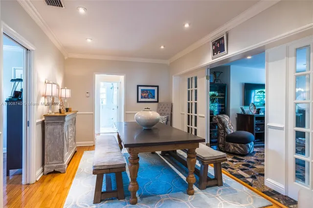 a living room with furniture a rug kitchen view and a large window