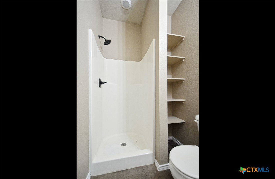 107 Rosedale Avenue New Braunfels, TX 78130 - Photo 11 of 21 a bathroom with a toilet and a shower