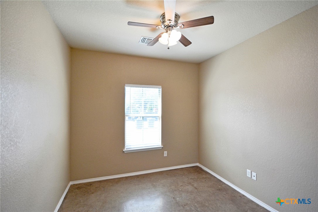 107 Rosedale Avenue New Braunfels, TX 78130 - Photo 12 of 21 an empty room with windows and fan