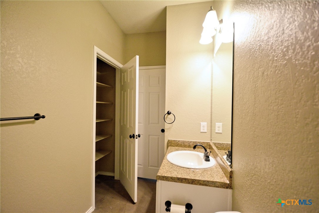 107 Rosedale Avenue New Braunfels, TX 78130 - Photo 17 of 21 a bathroom with a sink and a mirror