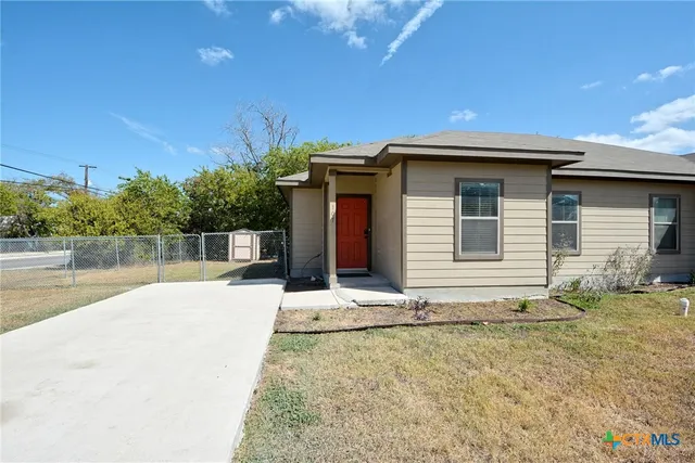 a house with trees in the background