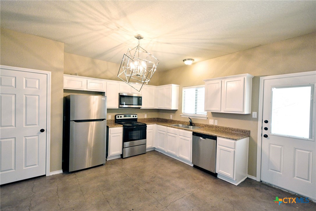 107 Rosedale Avenue New Braunfels, TX 78130 - Photo 7 of 21 a kitchen with cabinets and stainless steel appliances