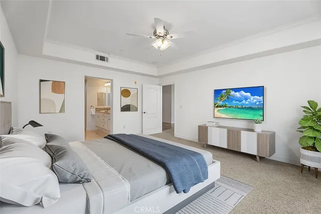 a bedroom with a large bed and a flat screen tv