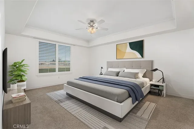 a spacious bedroom with a bed and a chandelier