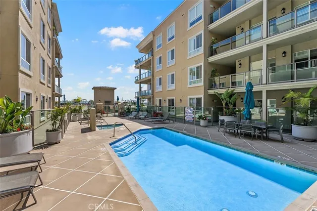 a view of a swimming pool with outdoor seating