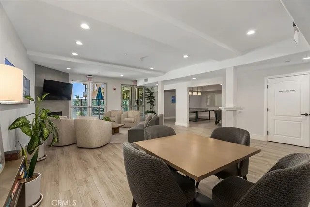 a living room with furniture a flat screen tv and a large window