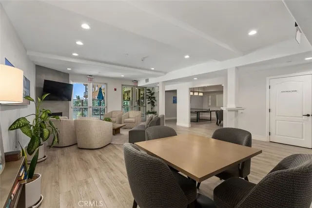 a living room with furniture a flat screen tv and a large window