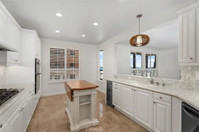 a spacious kitchen with stainless steel appliances granite countertop a sink and a stove
