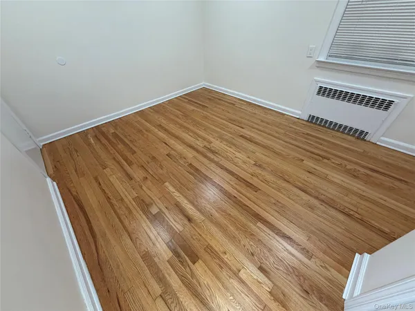 a view of a room with wooden floor