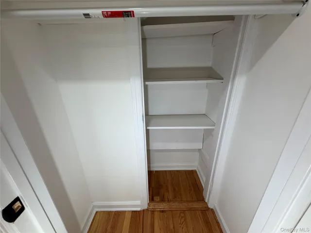 a view of walk in closet with wooden floor
