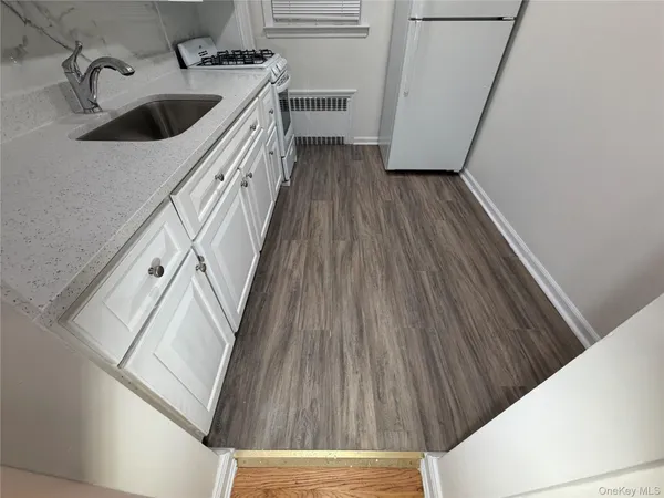 a kitchen with a sink a refrigerator and stove