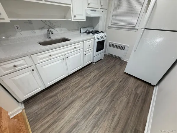 a kitchen with a sink a stove and cabinets